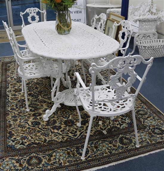 A white painted cast iron garden table and six chairs w.170cm